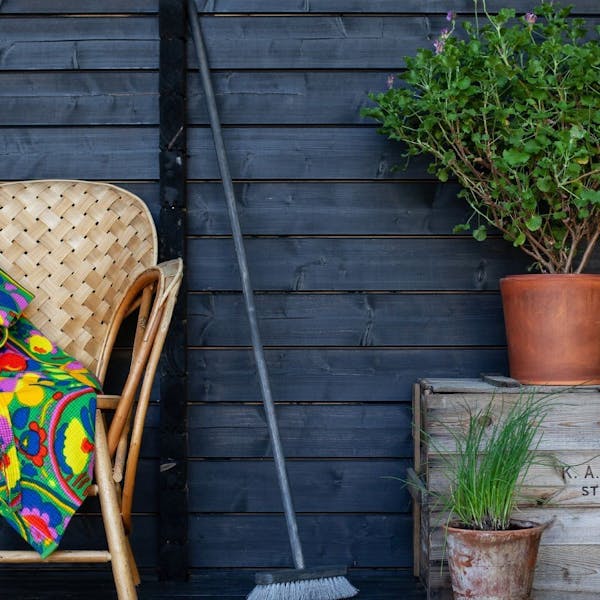 brush against wall with garden furniture