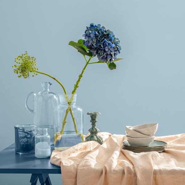 table with decorations in front of light blue wall