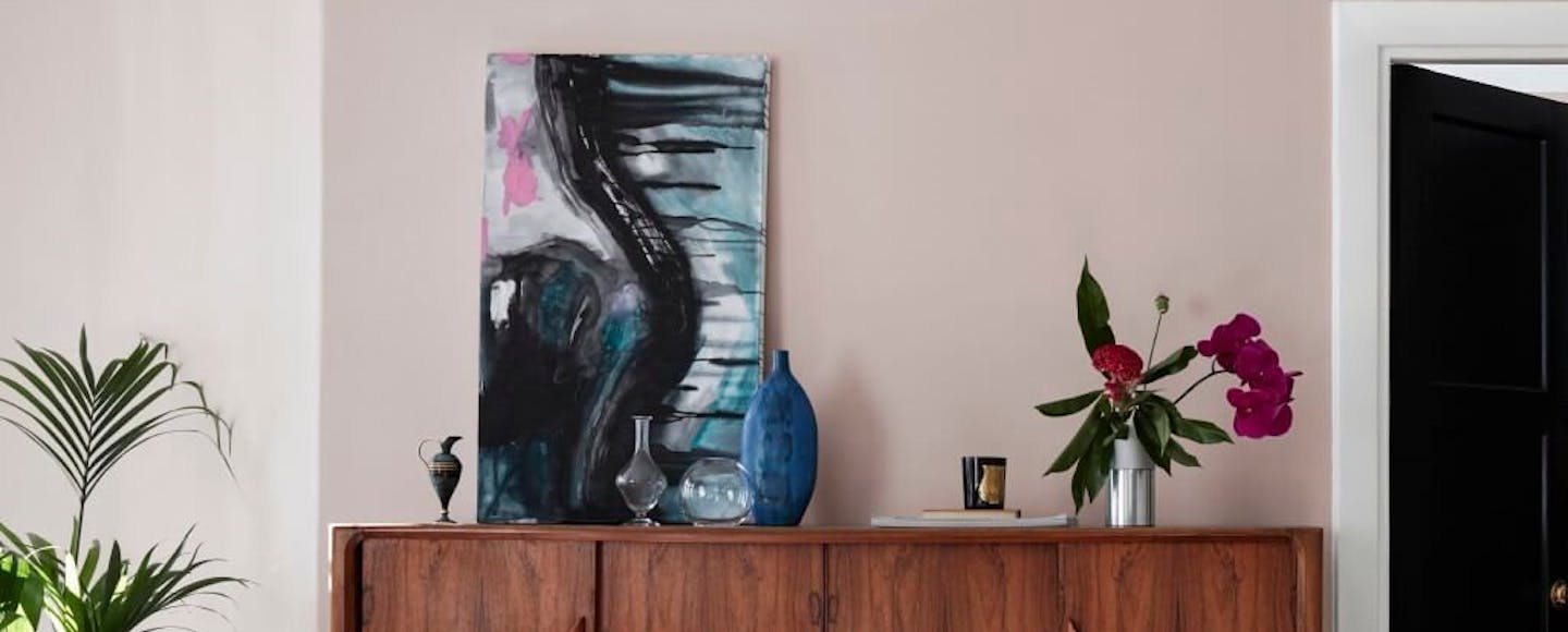 wooden cabinet against grey pink wall