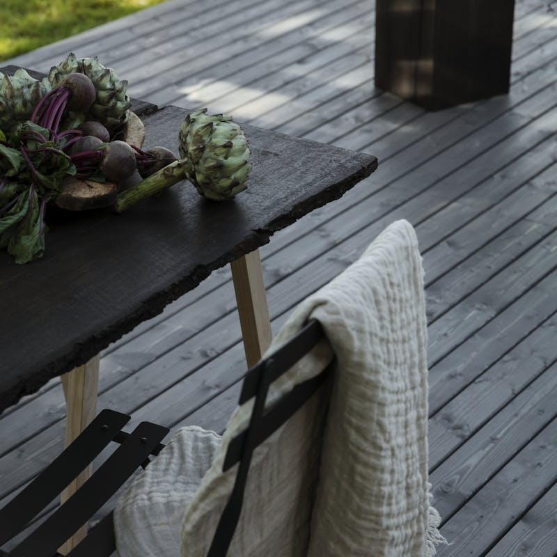Dark grey wooden furniture on dark grey terrace