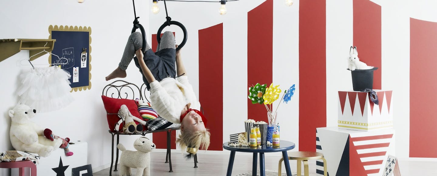 Kid playing in a circus themed bedroom
