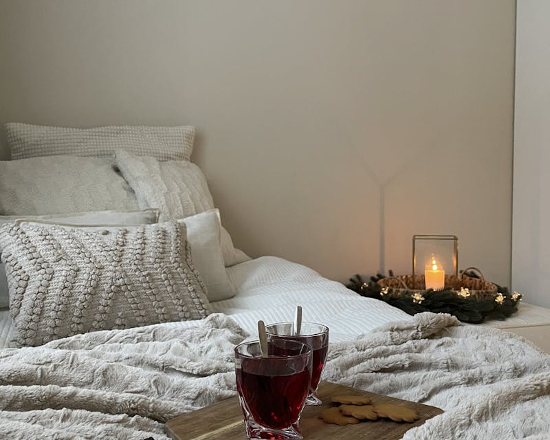 cosy bedroom setting candles and cushions