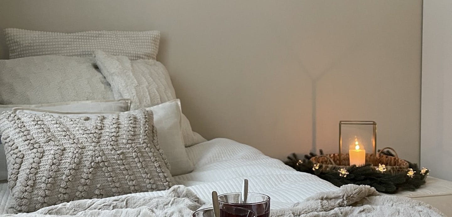 cosy bedroom setting candles and cushions