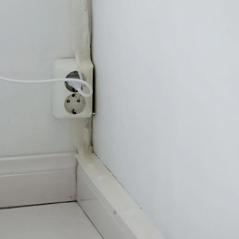 Corner of White Wall and White Double Socket
