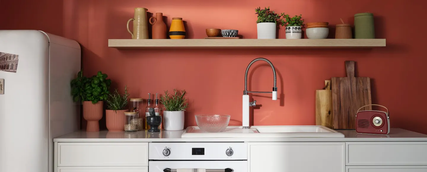 bright red kitchen wall with white cabinets