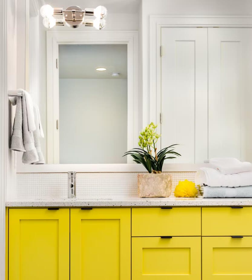 Clean open bathroom with bright yellow vanity unit