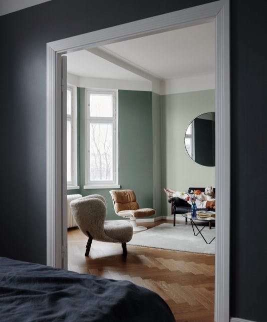 green living room view from dark blue bedroom