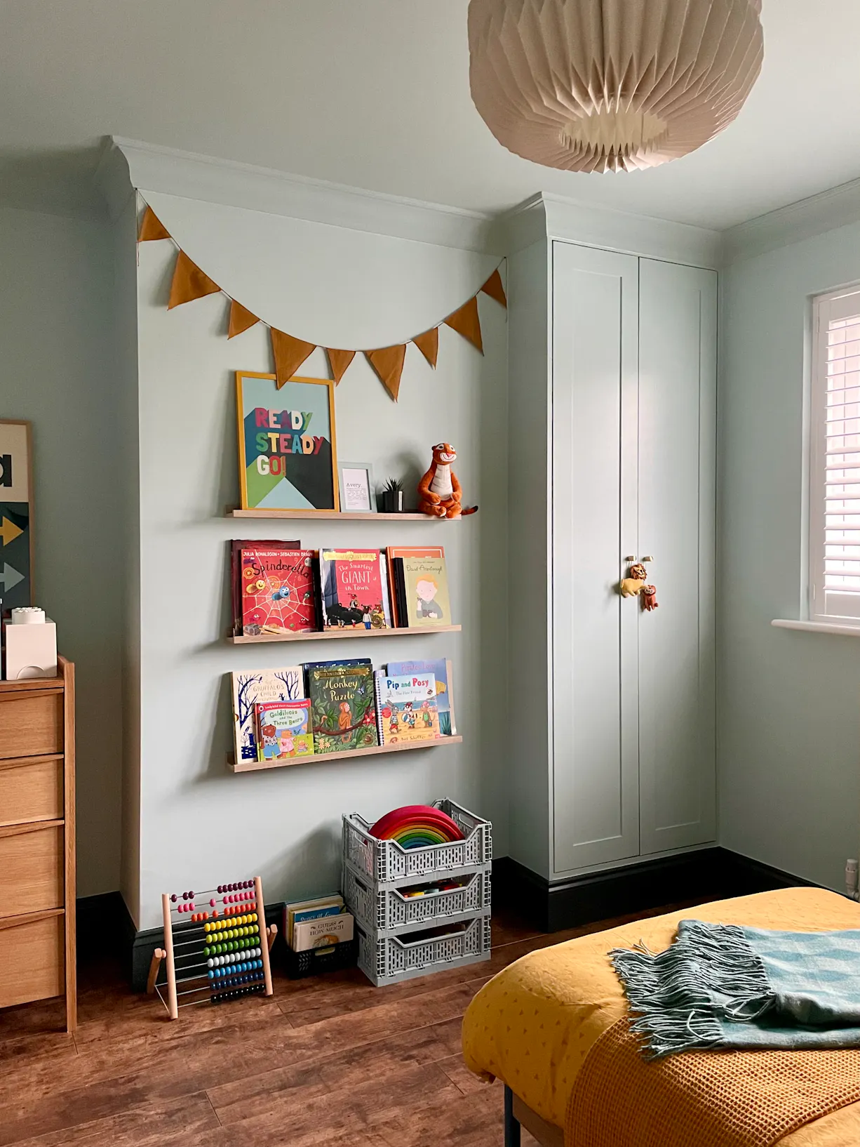 finished bedroom wall with shelves and books