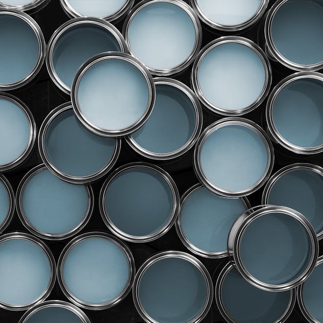 Multiple Open Paint Tins with Paint of Different Shades of Blue Inside