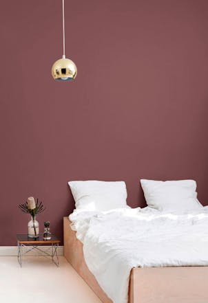 bedroom with a brighter maroon wall