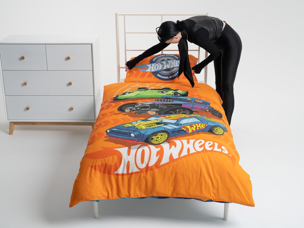 Stylist making a bed for a Hot Wheels photoshoot