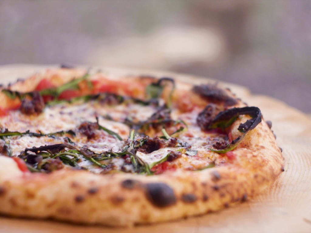 Fresh handmade sourdough pizza wooden block