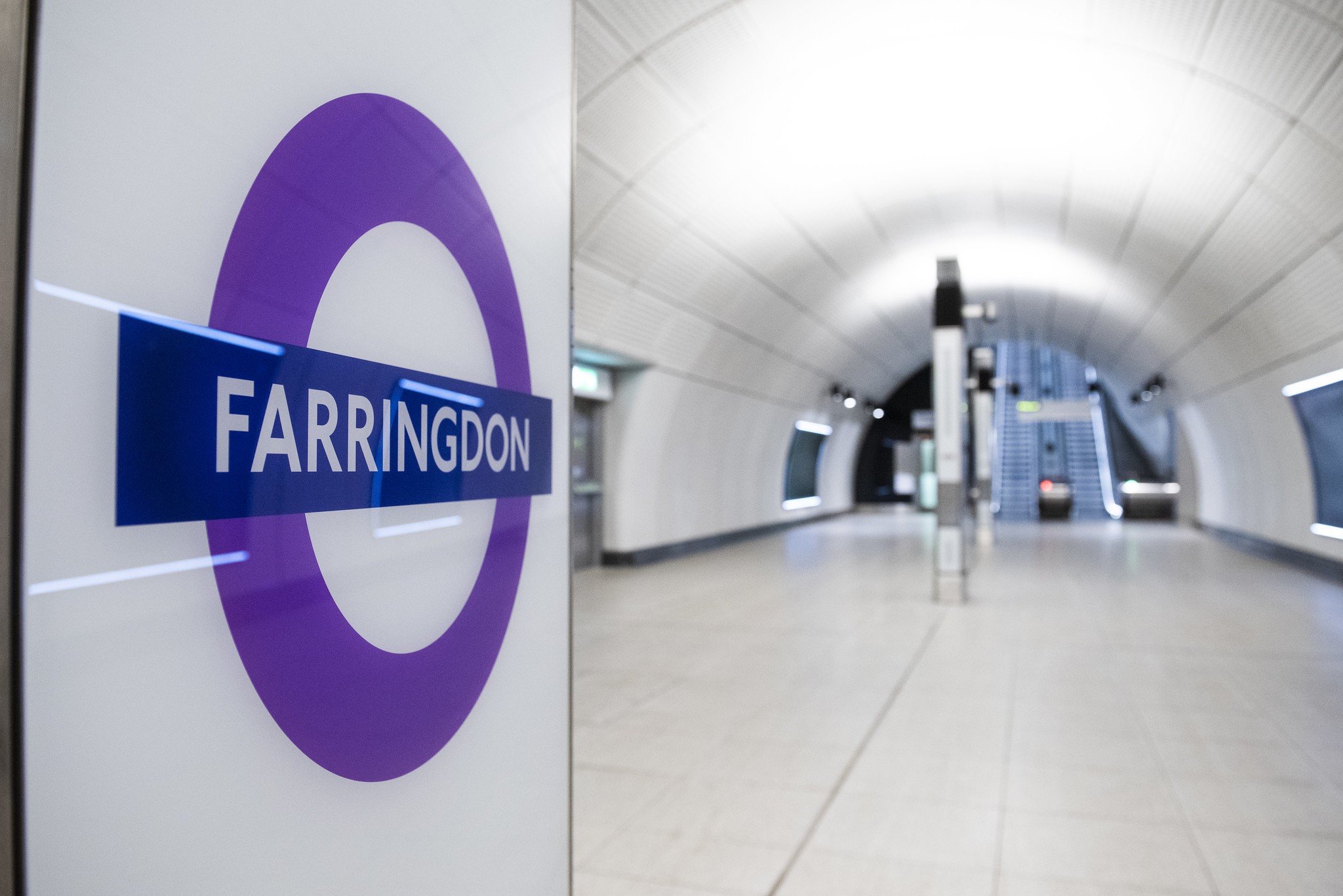 Empty underground station with sign saying Farringdon