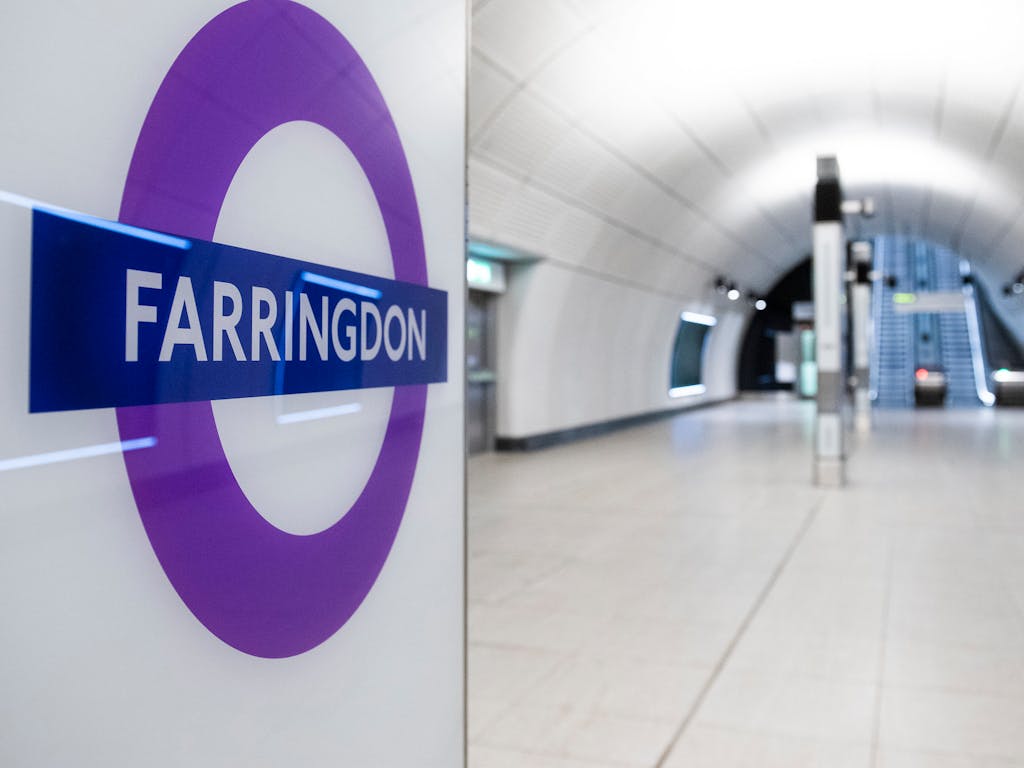 Empty underground station with sign saying Farringdon