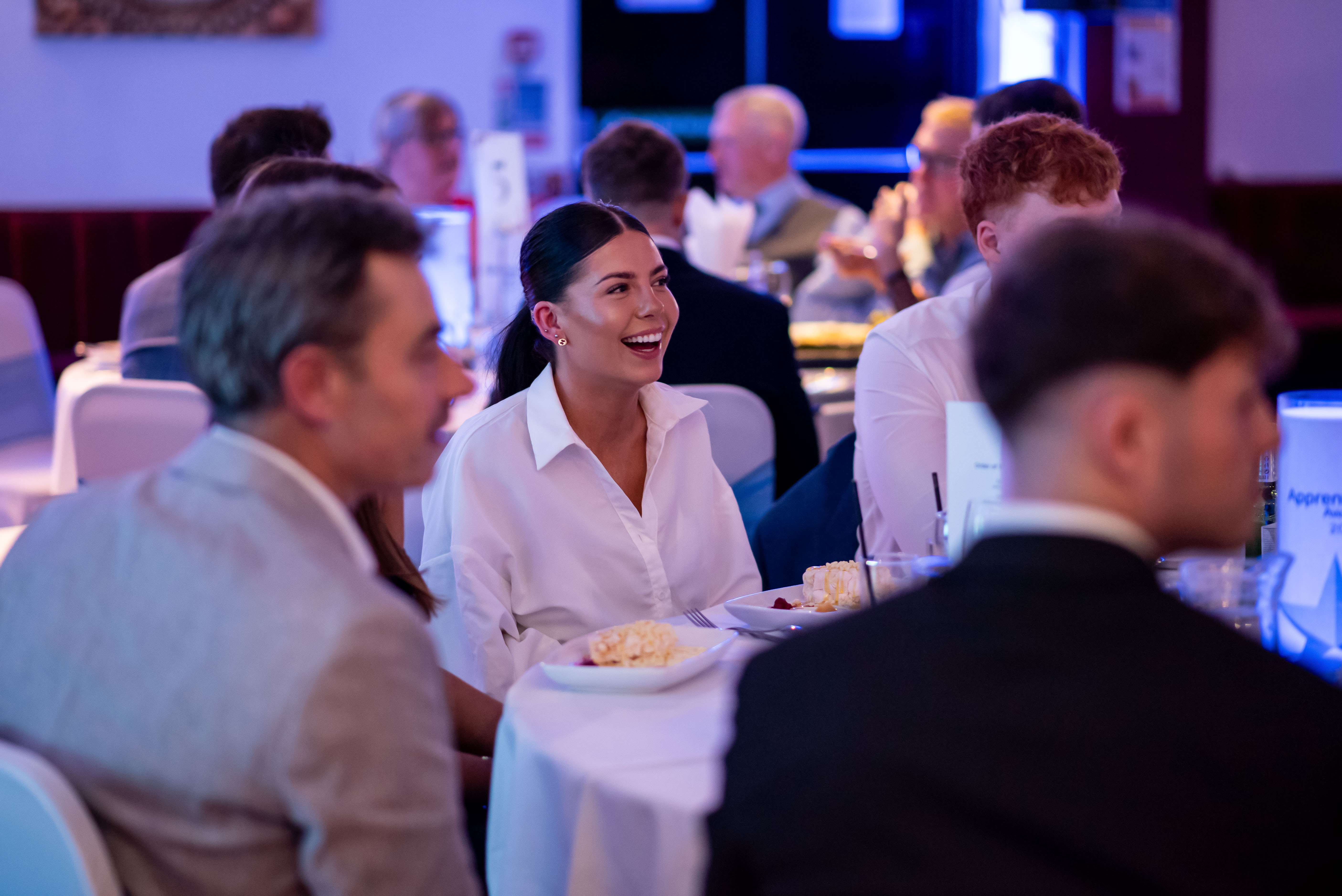 Lady laughing at corporate event sit down dinner