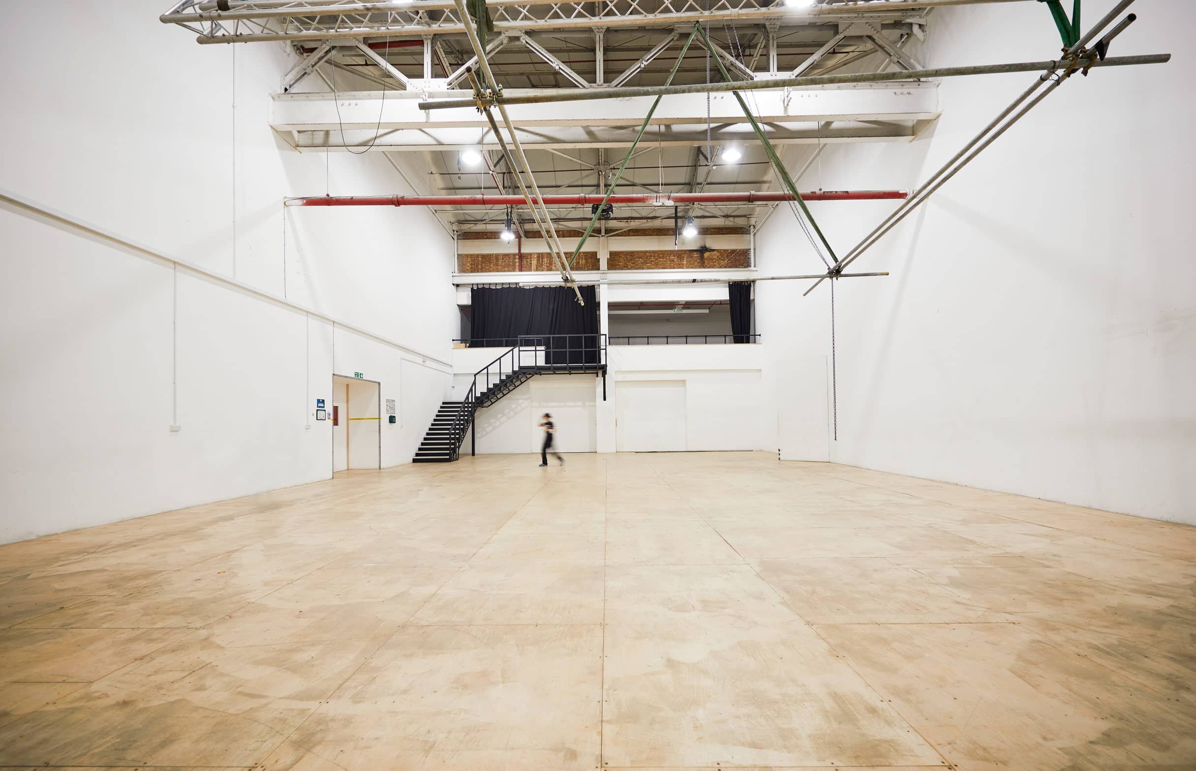 Large white warehouse with wooden floor