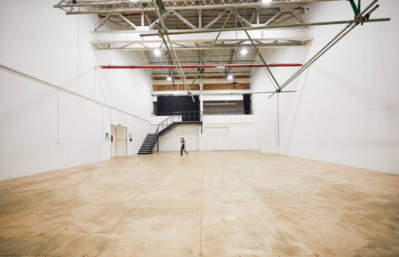 Large white warehouse with wooden floor