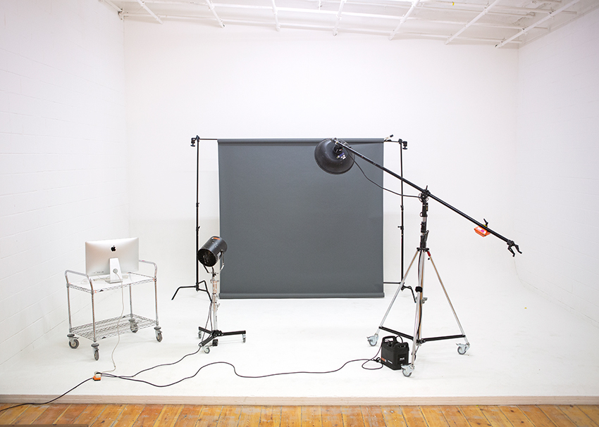 White photography studio with some lights and a grey backdrop