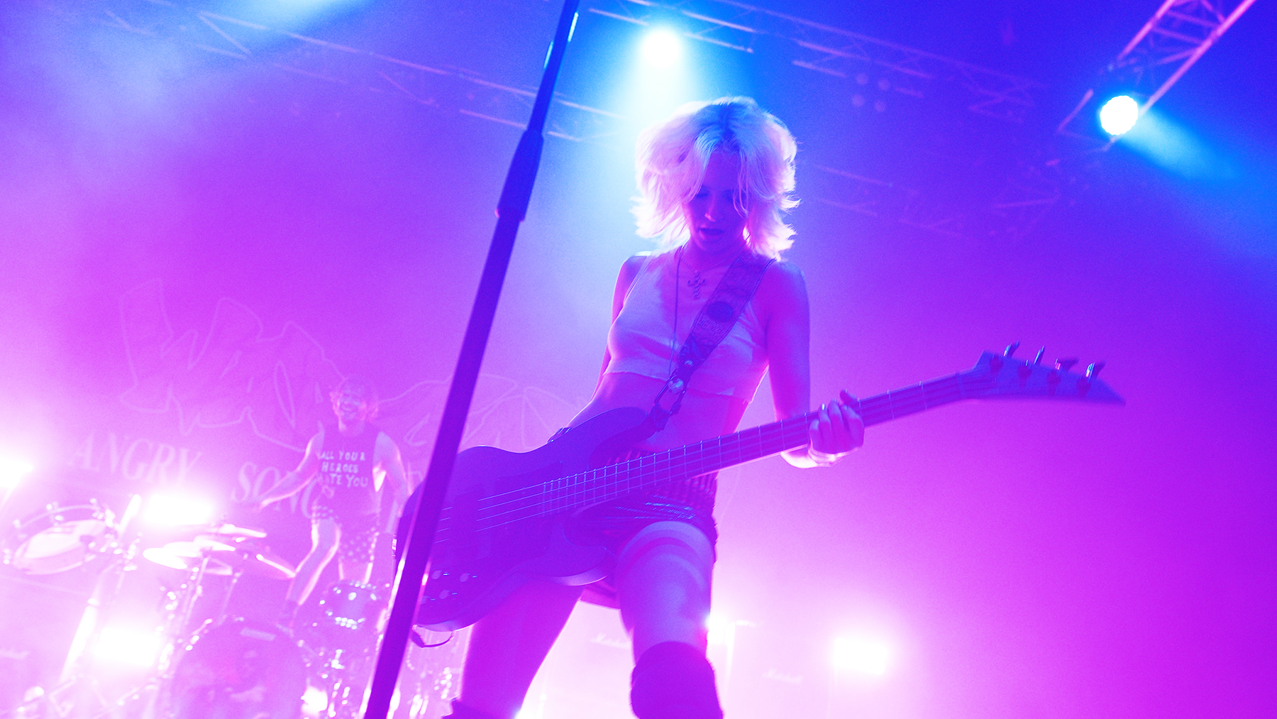 Rock performer: Milkie Way, from band Wargasm, on stage playing guitar