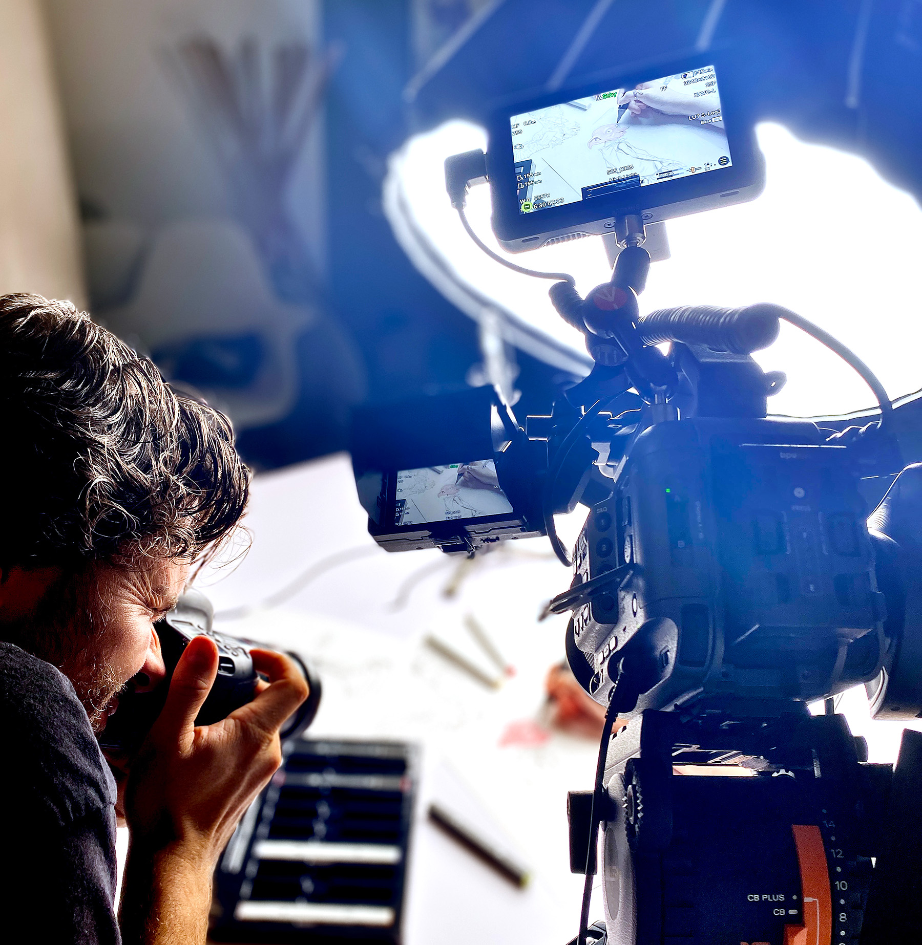 behind the scenes of film camera and photographer capturing an artist colour the house-elf character Dobby from the Harry Potter movies