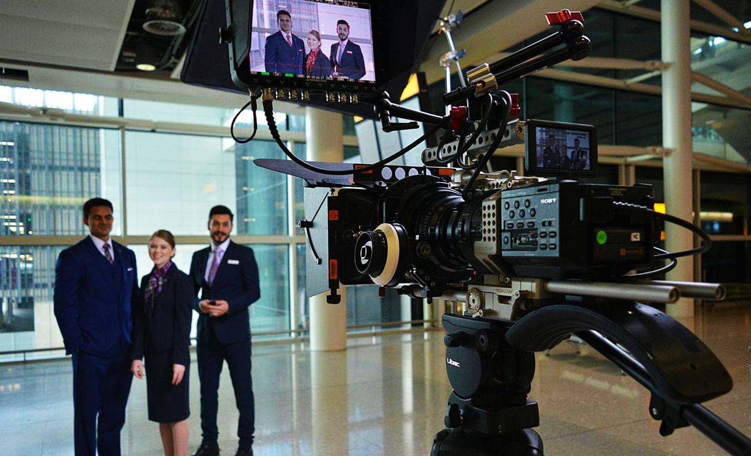 Video camera filming three corporate professionals