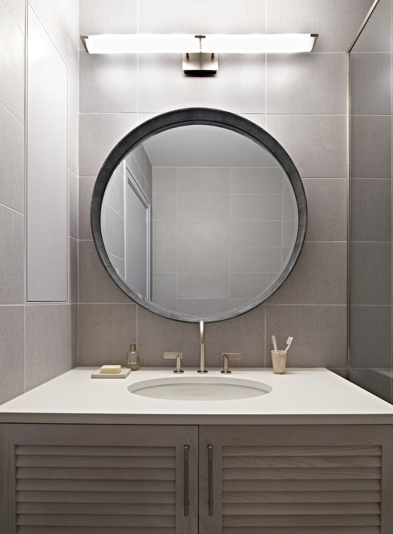 Tina-Ramchandani-Interior-Design-Quogue-Powder-Room-with-Circle-Mirror