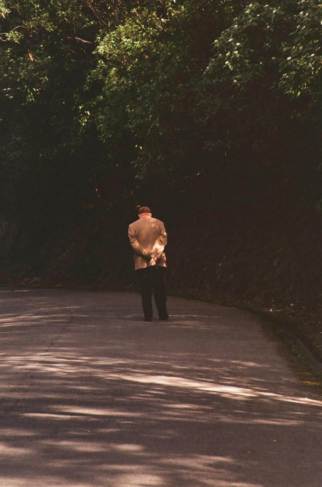 Old man walking along a path