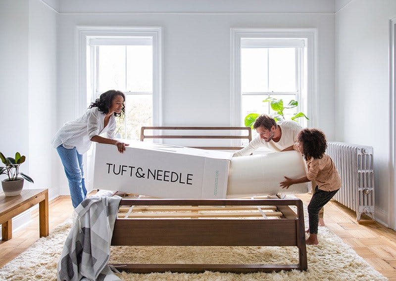 Family unboxing a Tuft and Needle Mattress