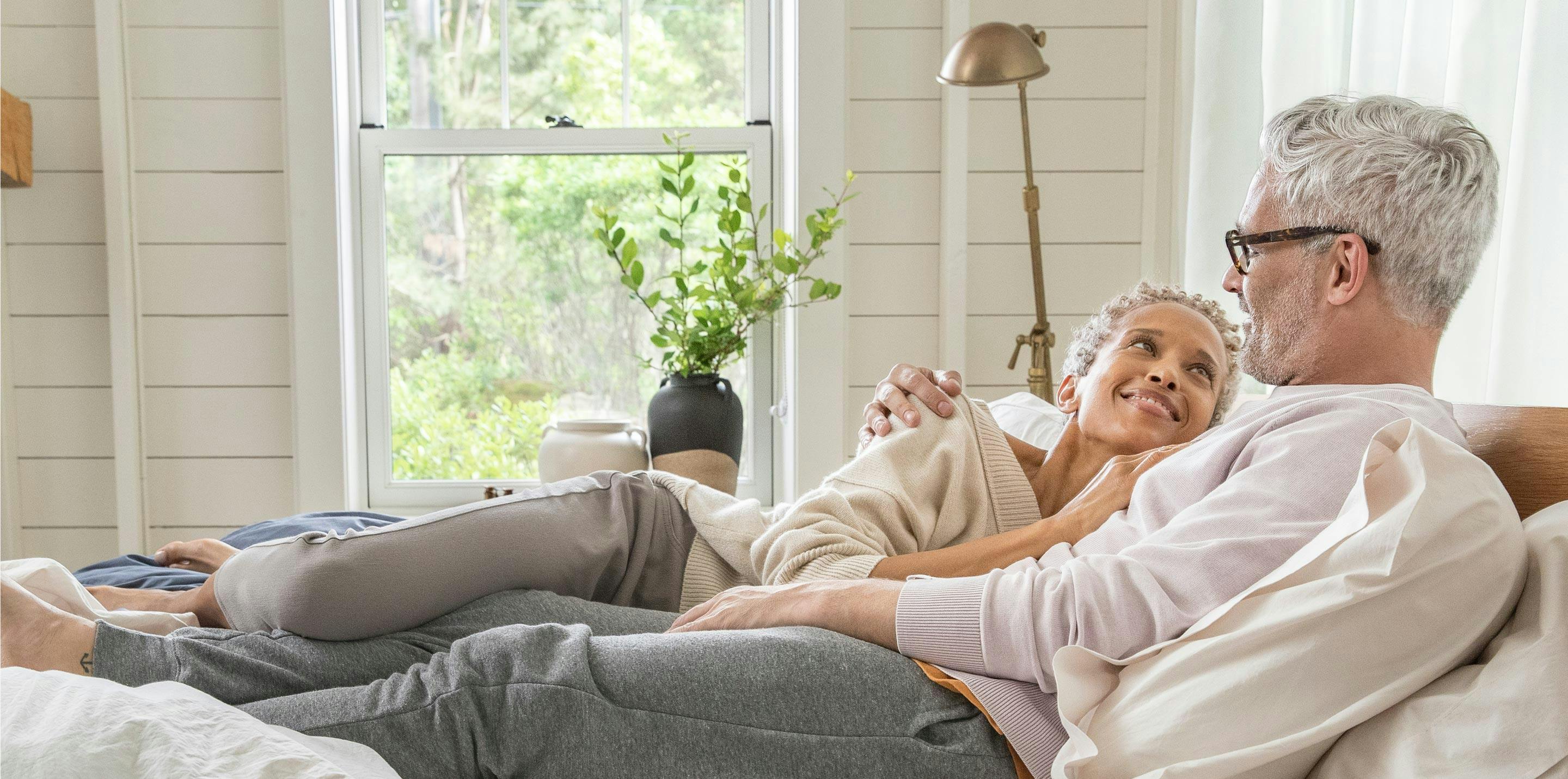 A man and woman laying in a bed