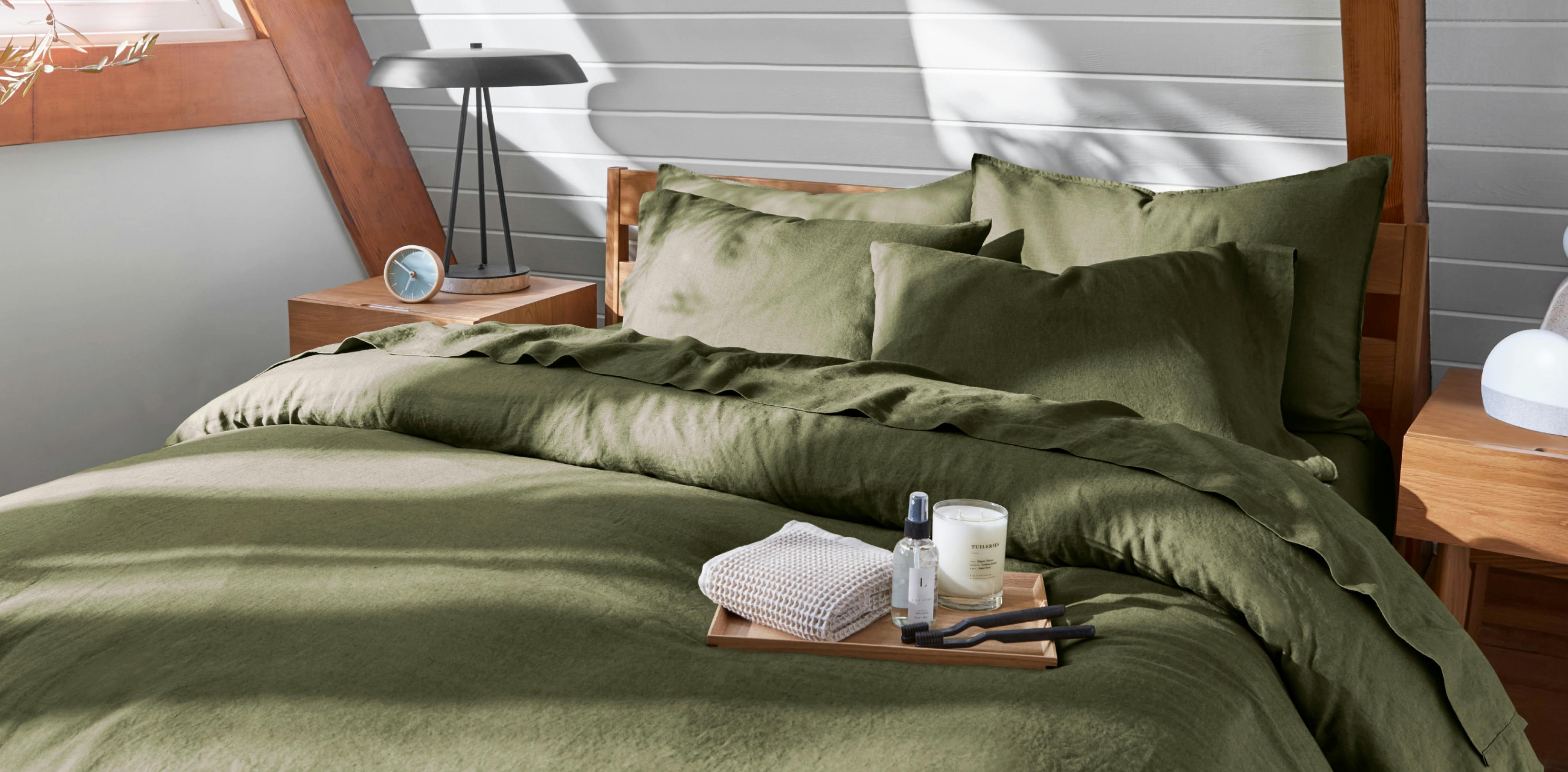 Linen Sheets and Duvet on made bed in Moss color.