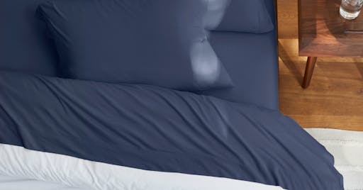 Organic Jersey Sheets on made bed in Blueberry color. 