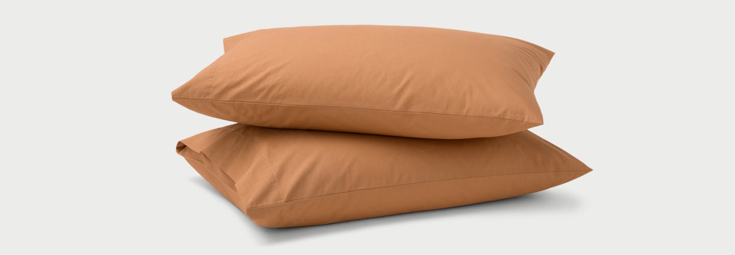 Two Percale Pillowcases on pillows in Canyon color.