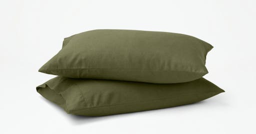 Two Linen Pillowcases on pillows in Moss color. 