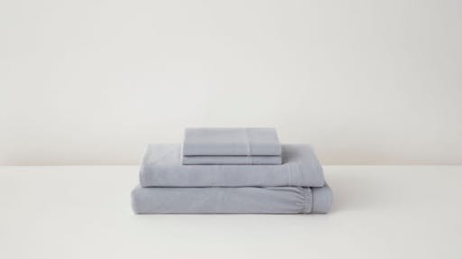 Folded jersey sheets and pillowcases in fog