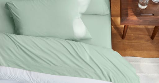 Organic Jersey Sheets on made bed in Pistachio color. 