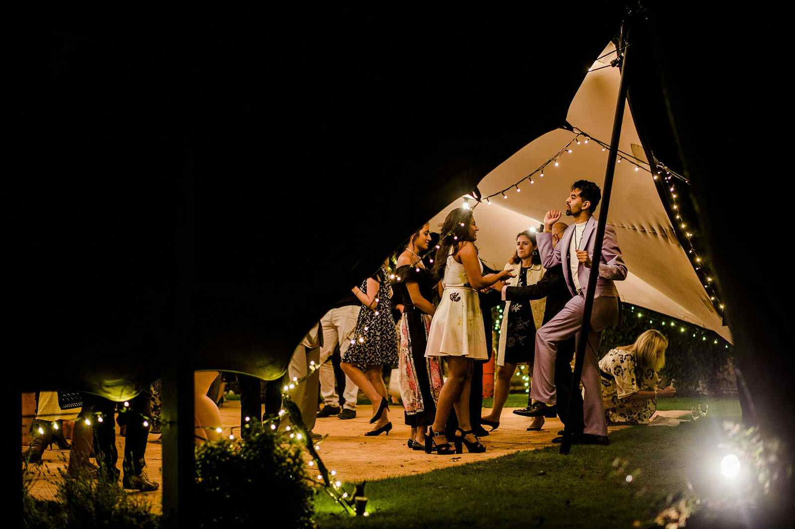 people dancing under a tent