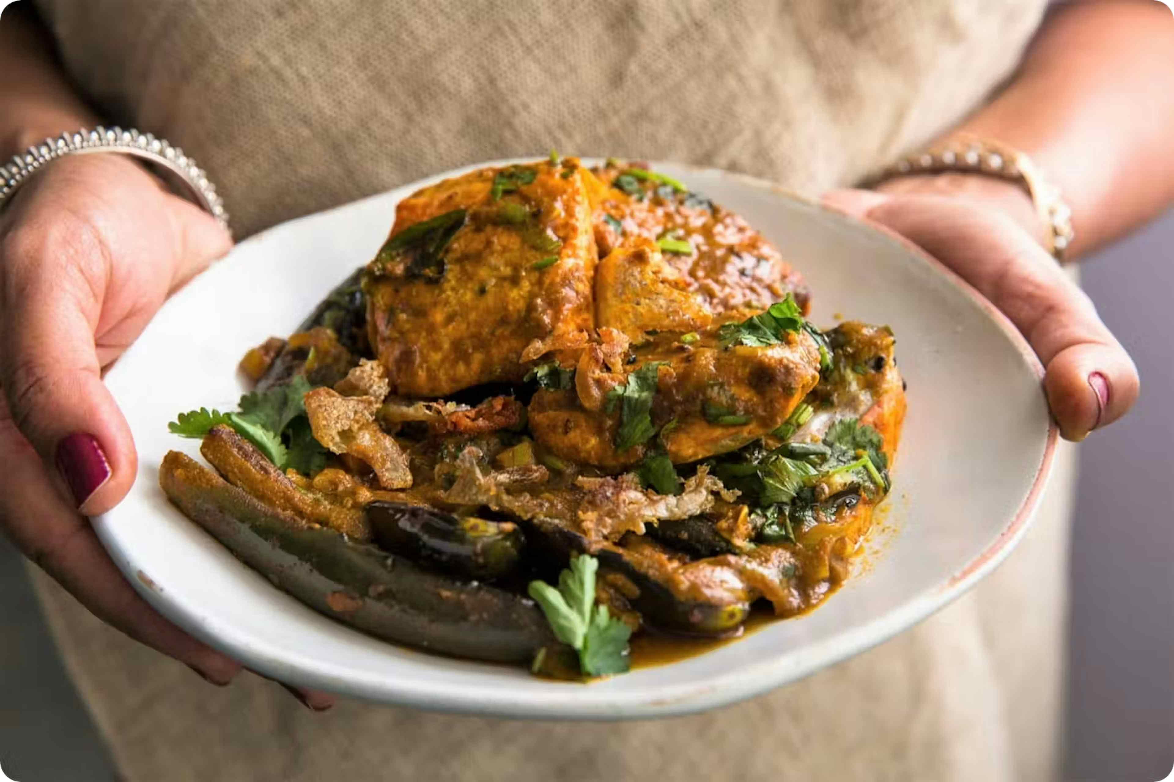 plate of food being held in 2 hands