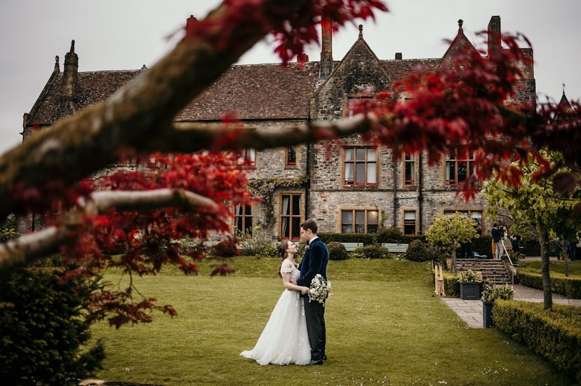 married couple in front of historic house 