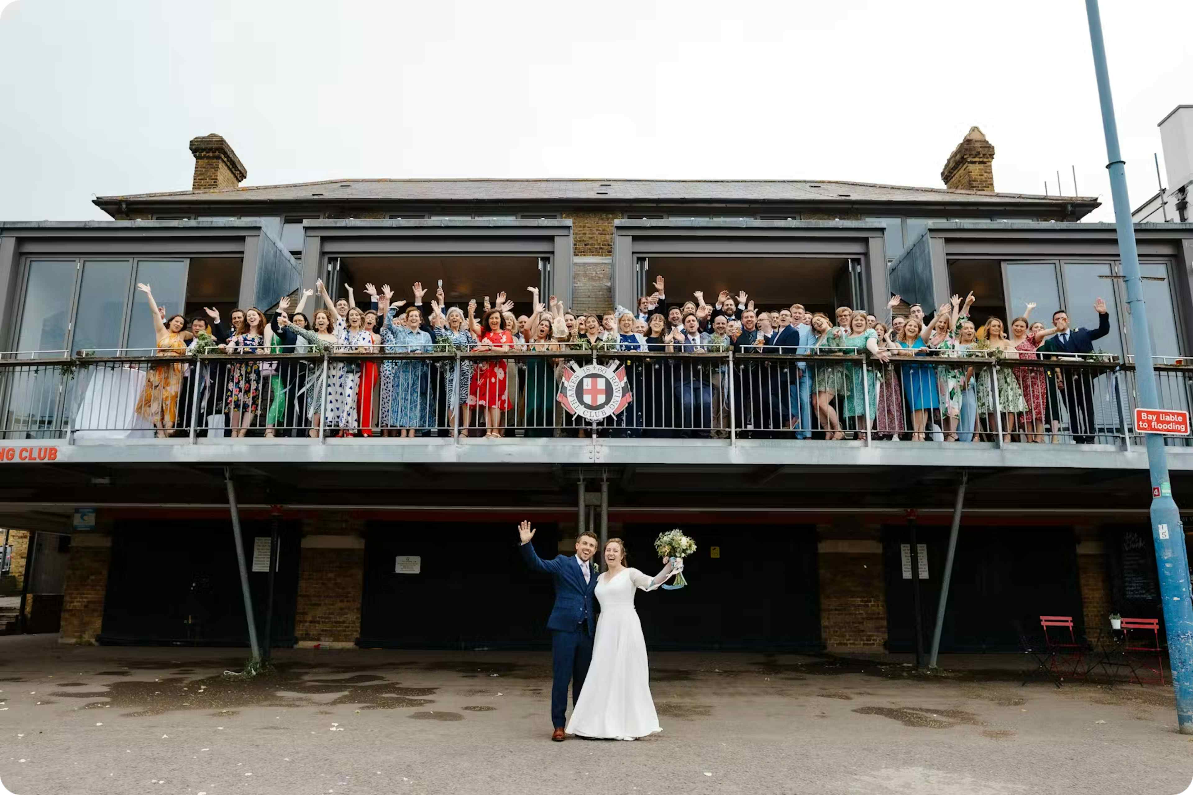 Couple married with friends on balcony