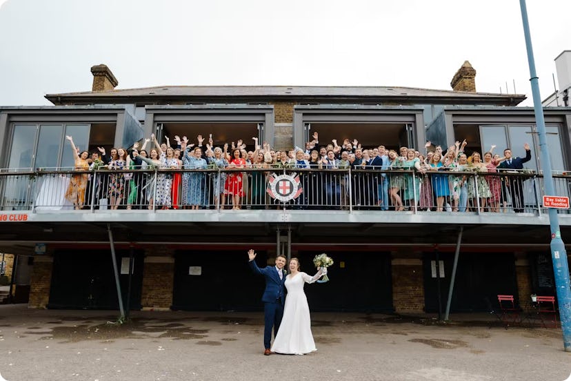 Couple married with friends on balcony