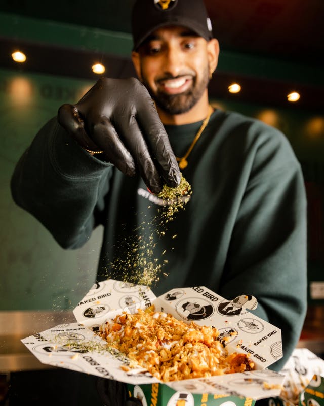 Putting the garnish on some street food from Baked Bird