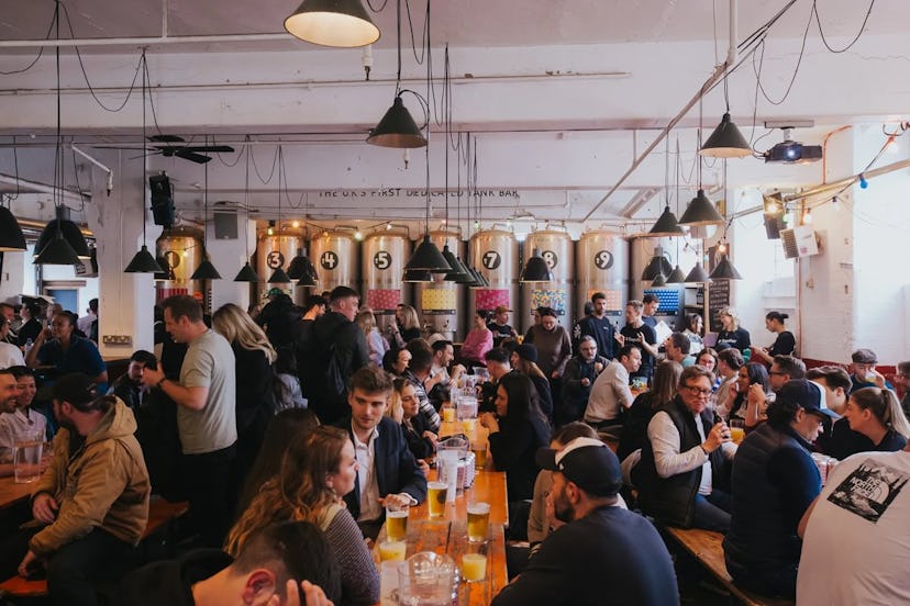 Long tables with people sitting drinking and chatting