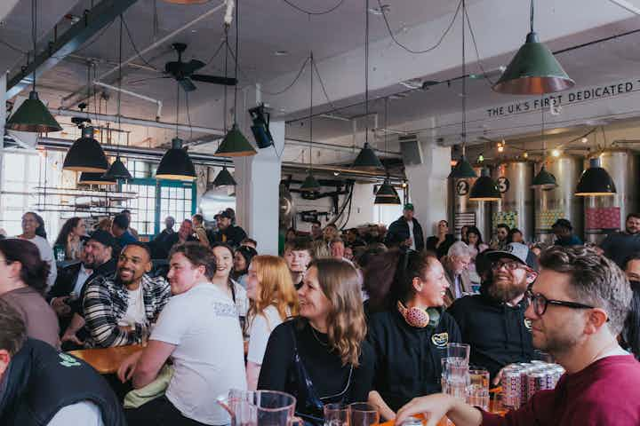 guests sitting at long tables smiling