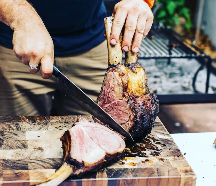 man cutting ribs with knife