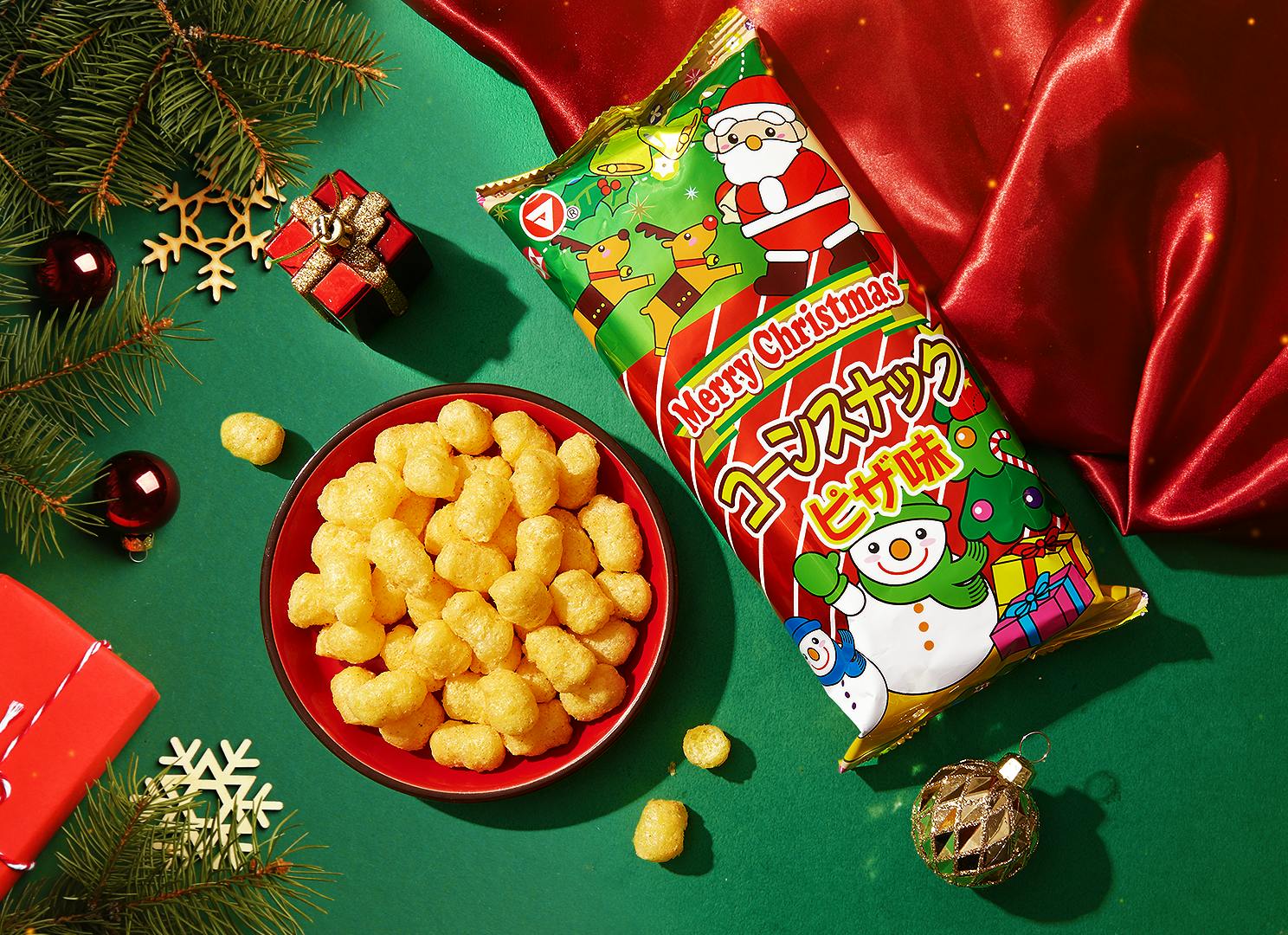 Christmas Corn Snacks sit on a holiday background surrounded by small presents, holly, and snowflake ornaments.