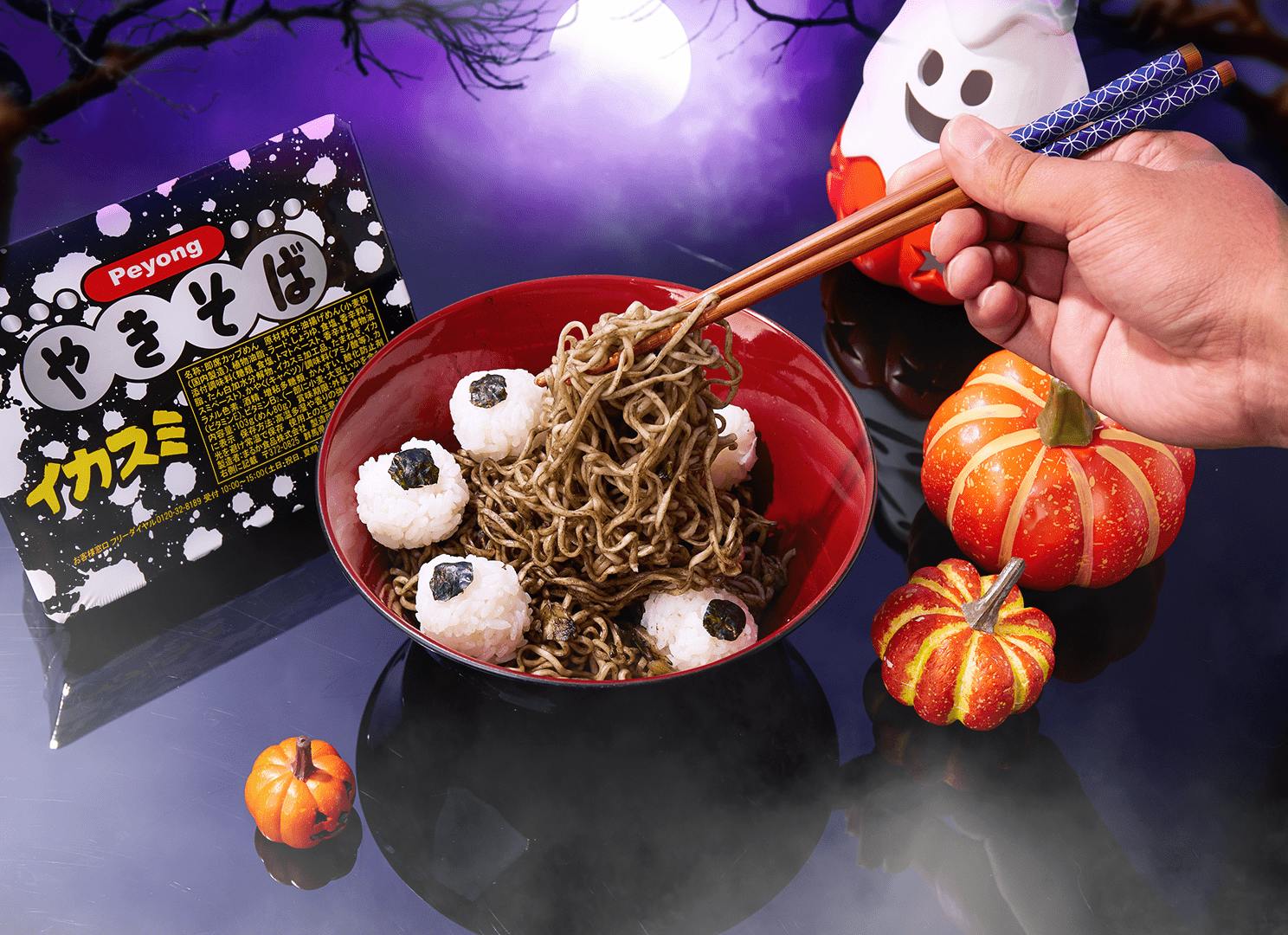 A man using chopsticks to eat Peyong squid ink Japanese noodles. A man using chopsticks to eat Peyong squid ink Japanese noodles.