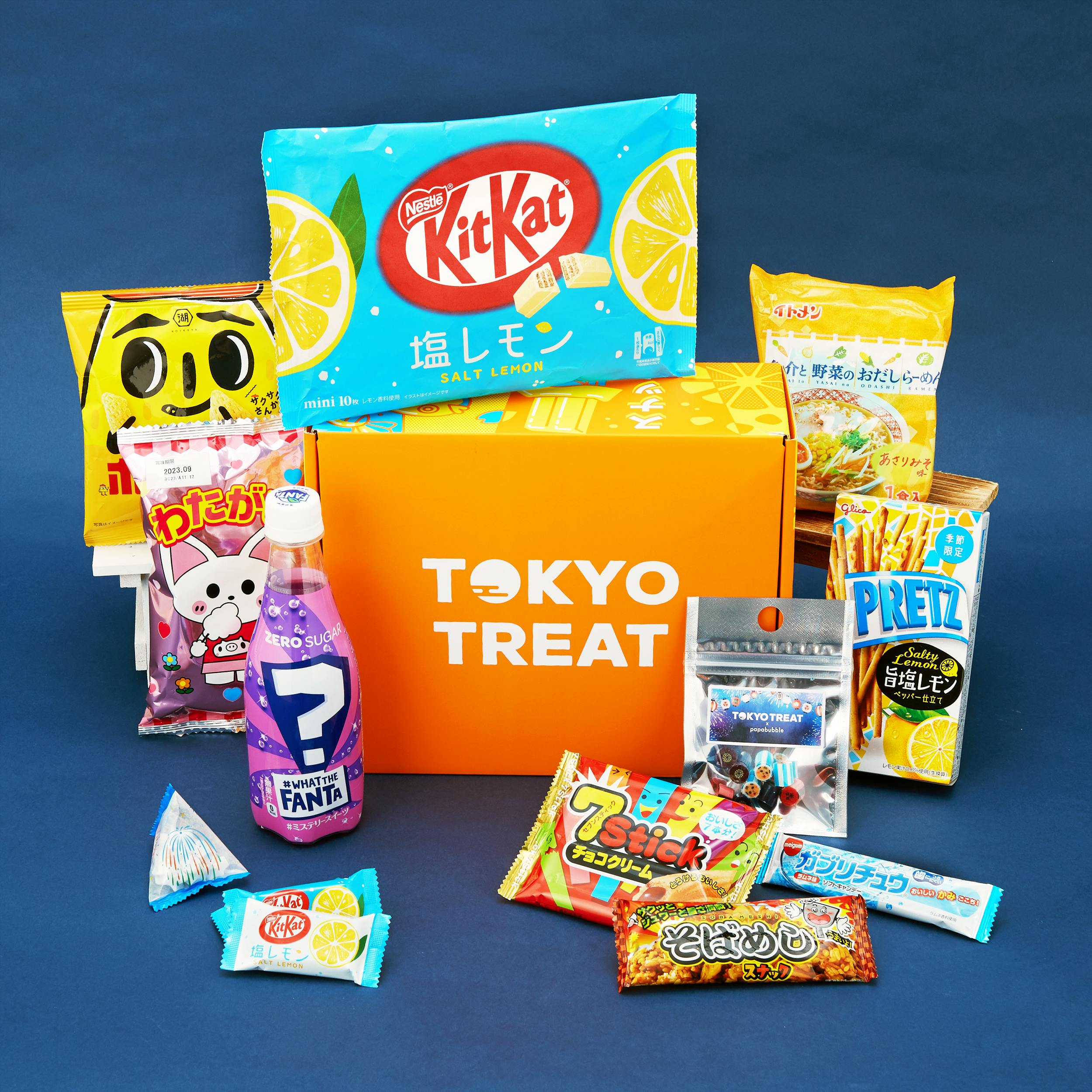 TokyoTreat's August box is displayed with colorful fireworks festival inspired snacks, noodles and drinks.