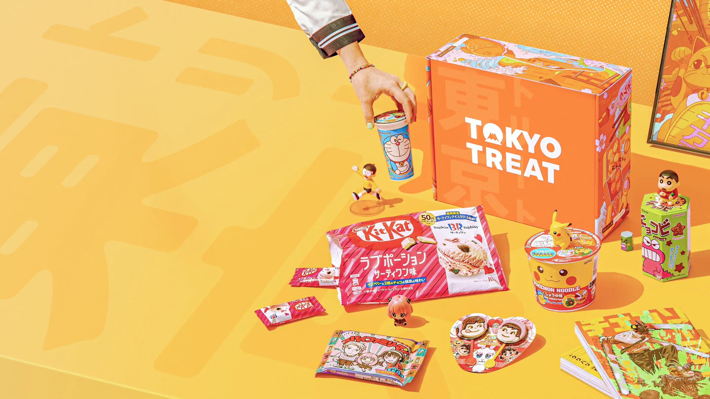 The TokyoTreat box surrounded by the most delicious Japanese snacks.