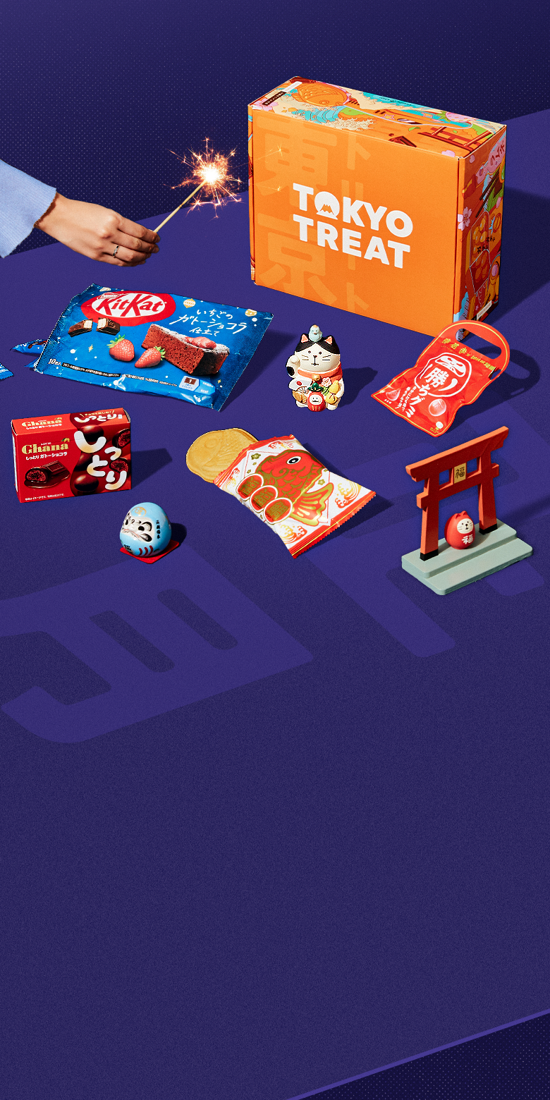 The New Year's Treatings Box on a blue background surrounded by snacks and New Year's props.