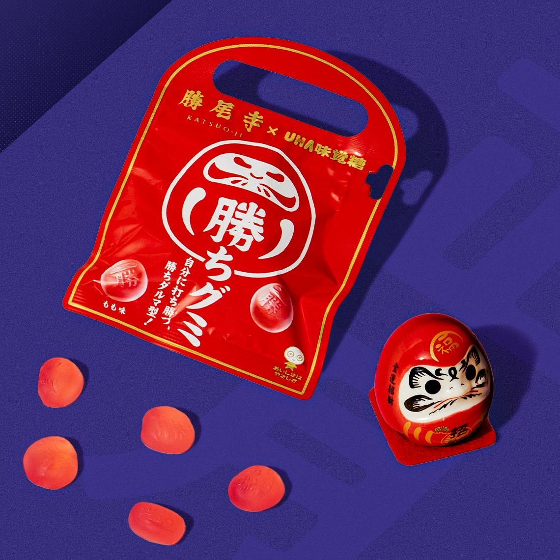 Daruma gummies on a blue background.